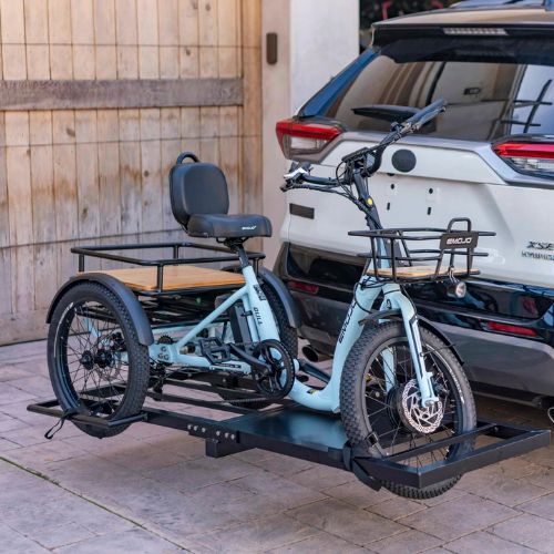 Electric trike with rear cargo rack mounted on a car hitch carrier outdoors