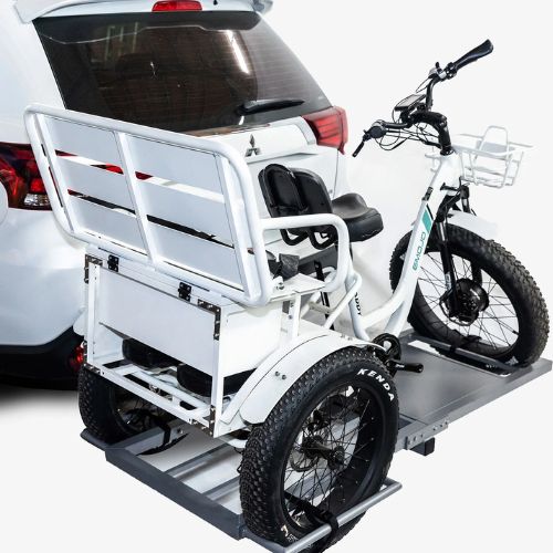 Electric trike with cargo rack mounted on car hitch, fat tires, ready for transport